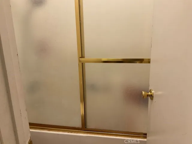 a bathroom with a glass shower door