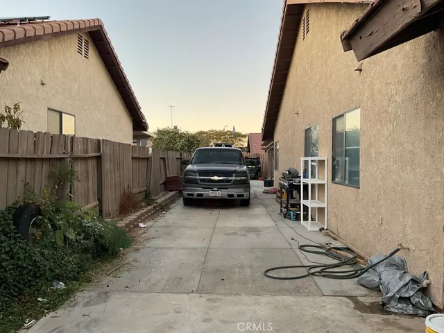 a view of a car park in front of a house