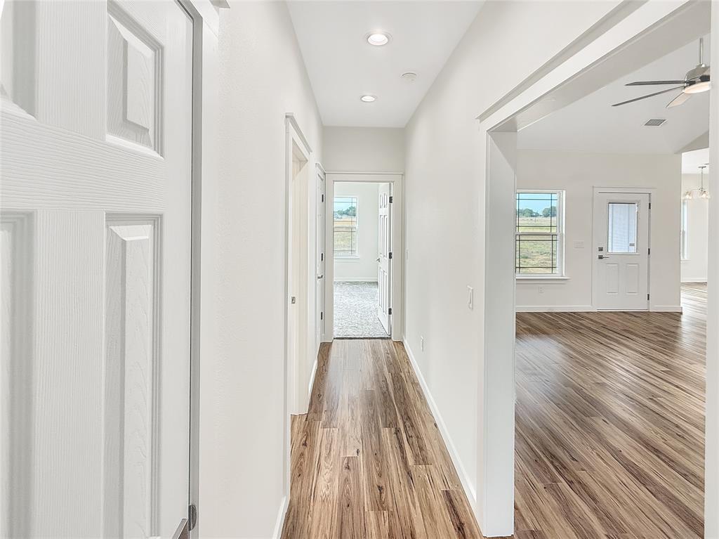6472 Old Clarksville Road Reno, TX 75462 - Photo 19 of 22 a view of a hallway with wooden floor and staircase