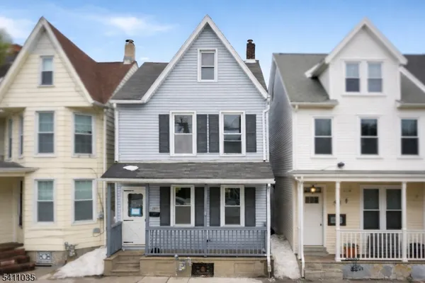 a view of a white house with large windows