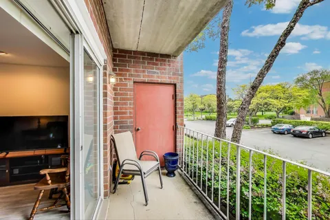a view of a balcony with chairs