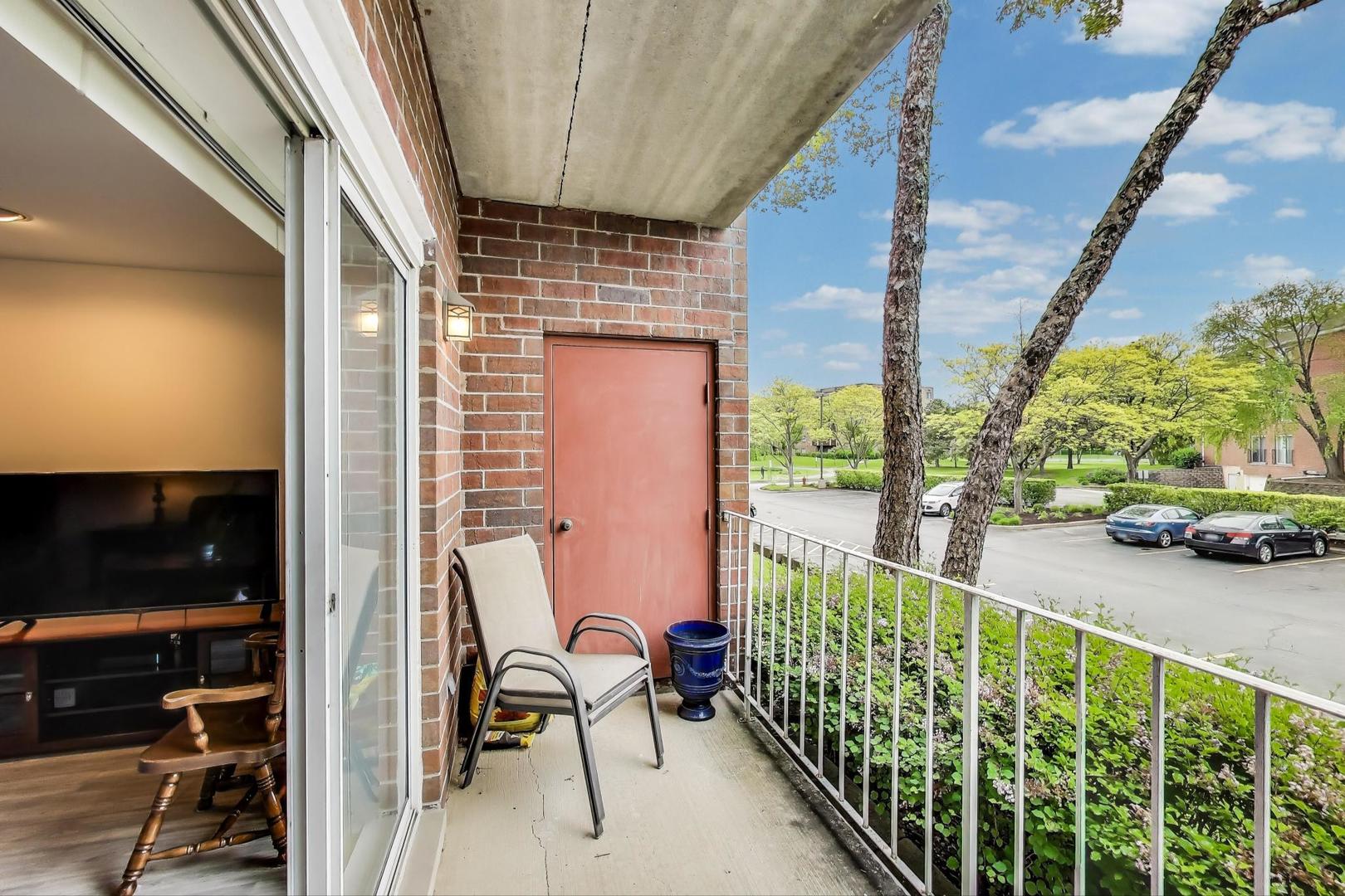 805 Leicester Road, Unit B105 Elk Grove Village, IL 60007 - Photo 20 of 37 a view of a balcony with chairs