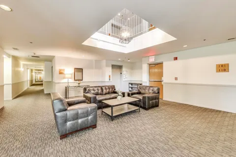 a living room with furniture and white walls