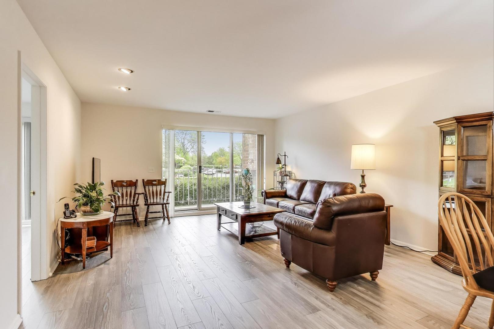 805 Leicester Road, Unit B105 Elk Grove Village, IL 60007 - Photo 5 of 37 a living room with furniture and a wooden floor