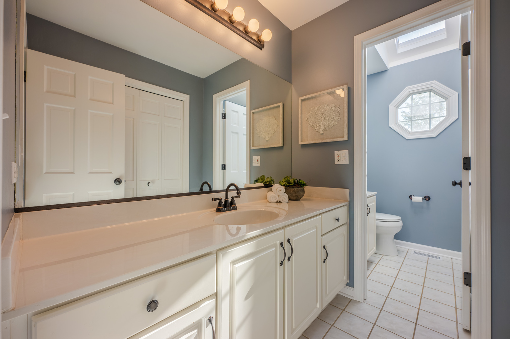 2004 Eldorado Drive Geneva, IL 60134 - Photo 19 of 26 a bathroom with a double vanity sink and a mirror
