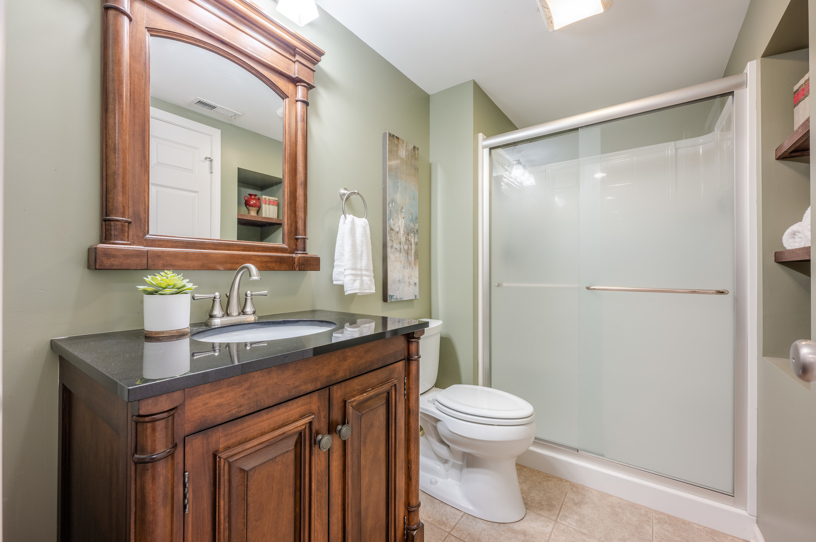 2004 Eldorado Drive Geneva, IL 60134 - Photo 23 of 26 a bathroom with a granite countertop sink toilet a mirror and shower
