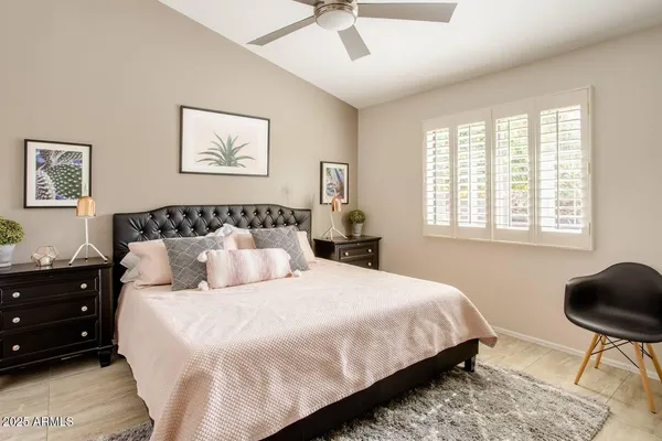 a bedroom with bed chair and window