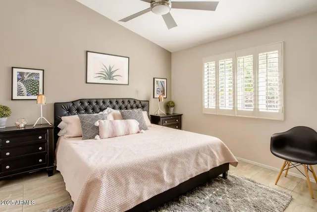 a bedroom with bed chair and window