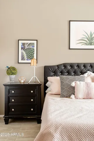 a bedroom with a bed and a painting on the wall