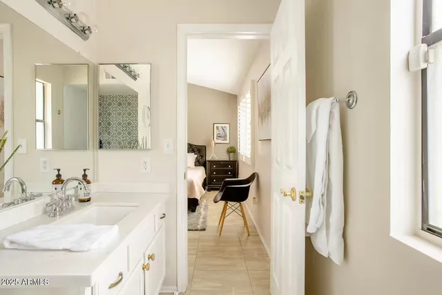 a en suite bathroom with a sink and a mirror