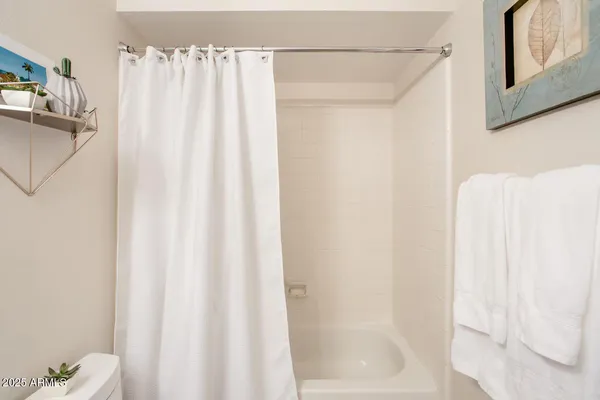 a bathroom with a shower and a tub