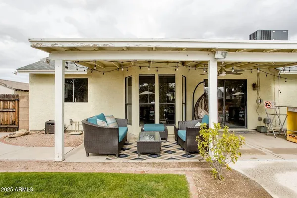 a view of two chairs in the patio