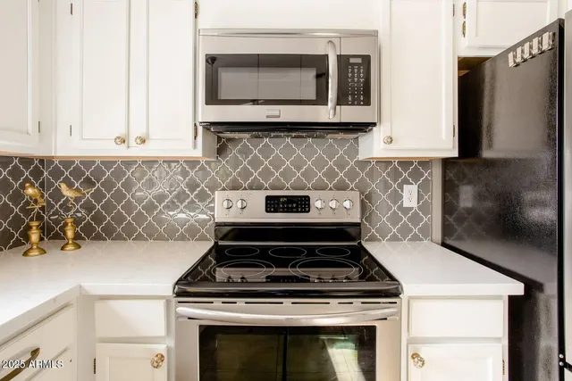a stove top oven sitting inside of a kitchen