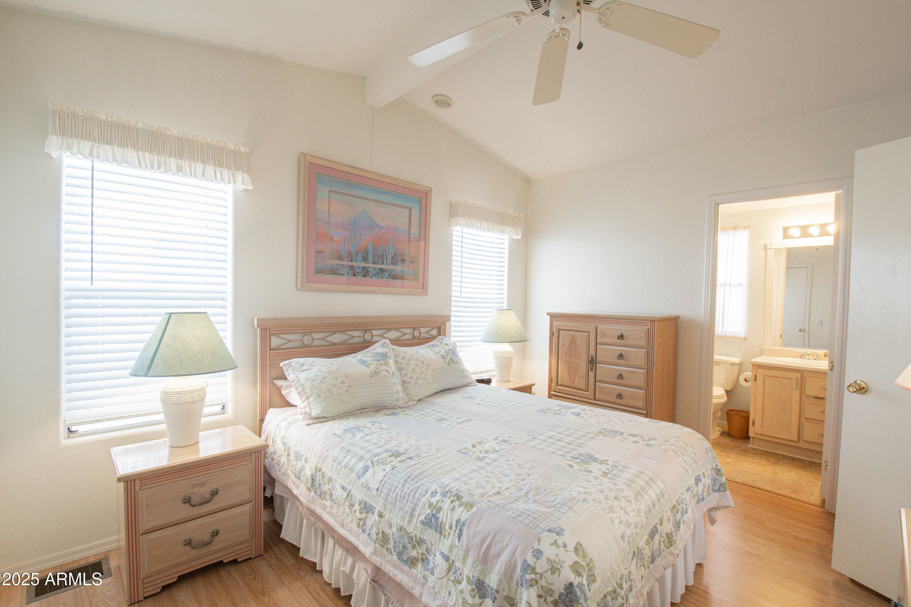 5735 East McDowell Road, Unit 410 Mesa, AZ 85215 - Photo 14 of 45 a bedroom with a bed and a chandelier