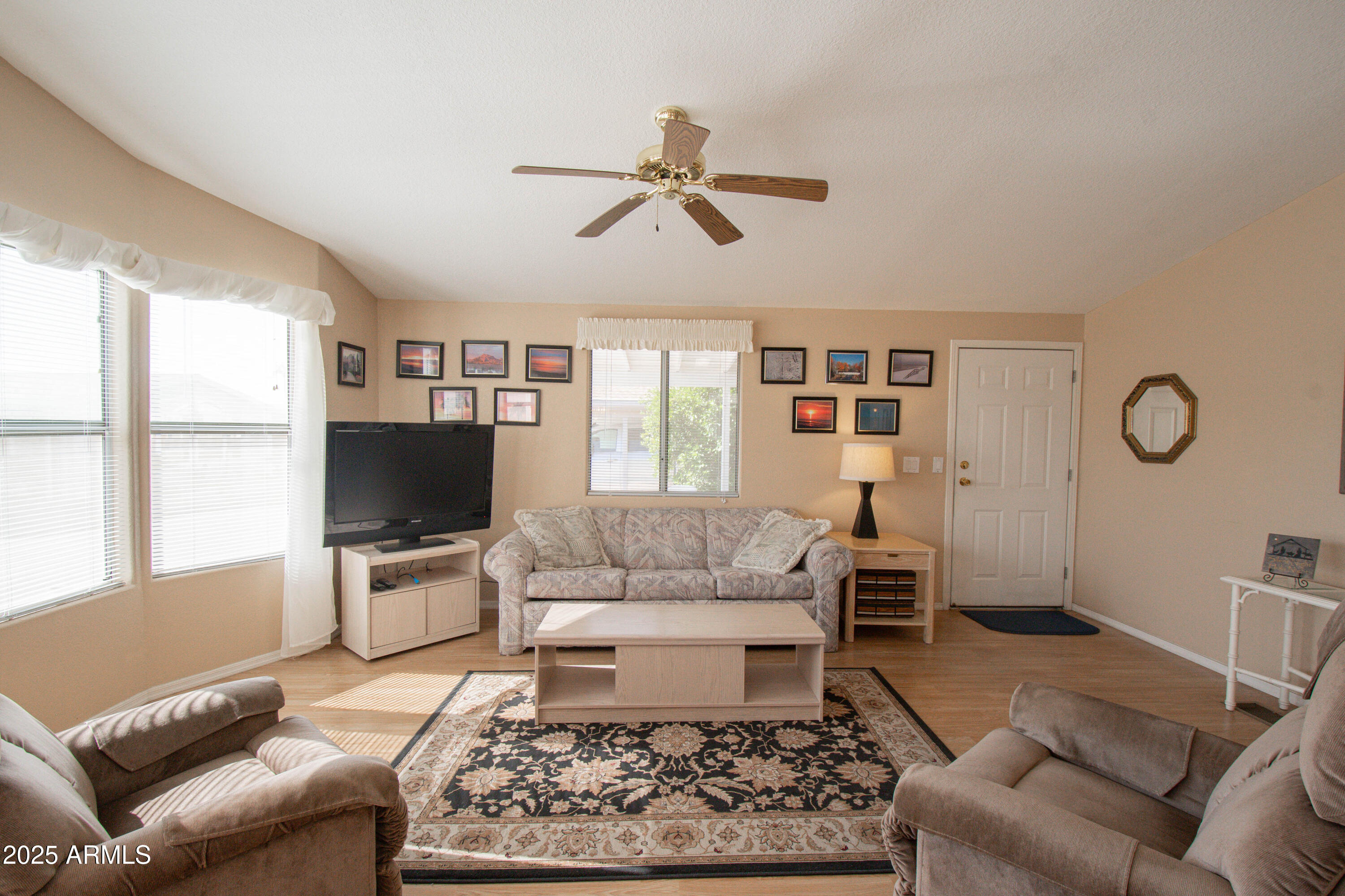 5735 East McDowell Road, Unit 410 Mesa, AZ 85215 - Photo 6 of 45 a living room with furniture a rug and a flat screen tv