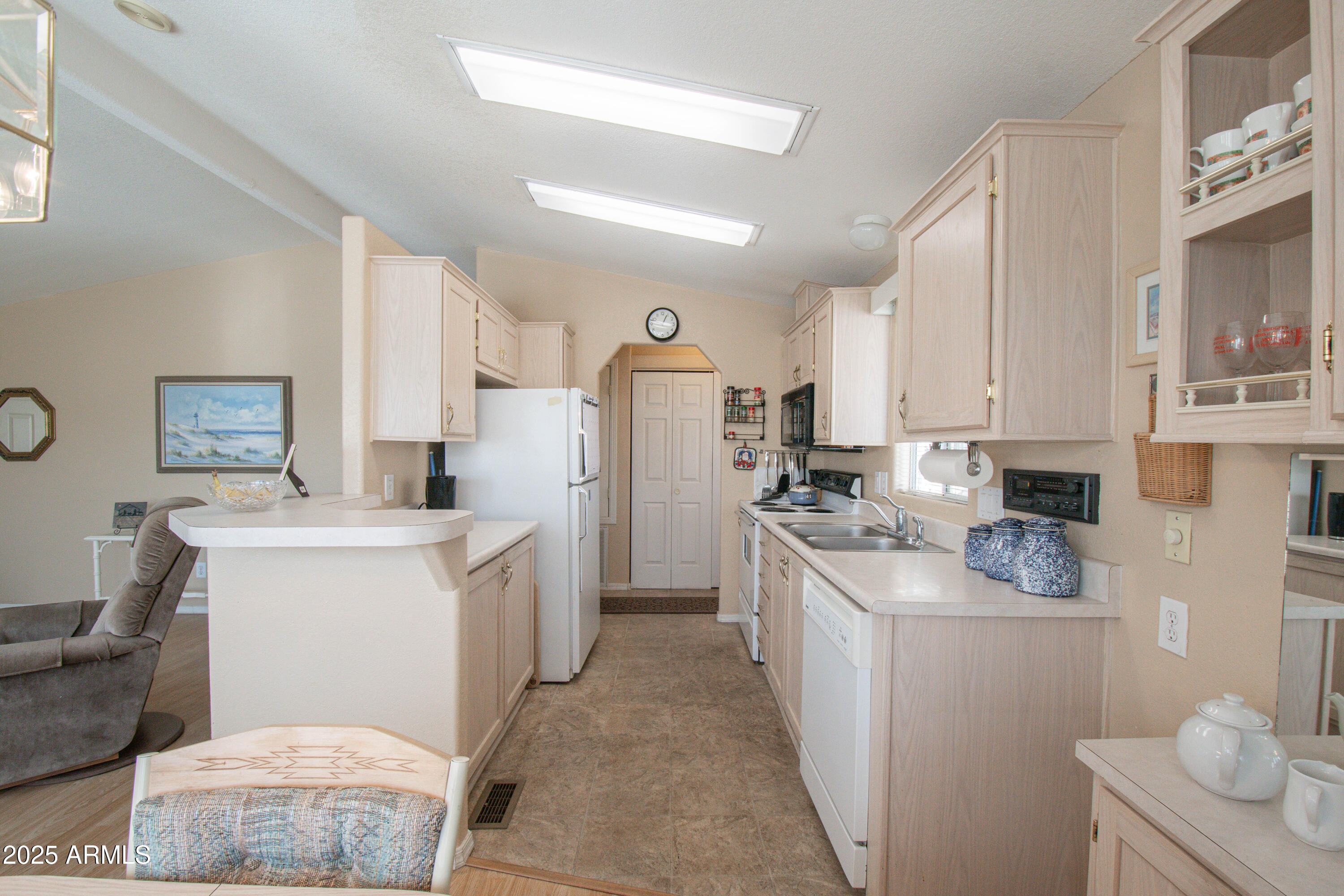 5735 East McDowell Road, Unit 410 Mesa, AZ 85215 - Photo 8 of 45 a kitchen with a sink stove and refrigerator