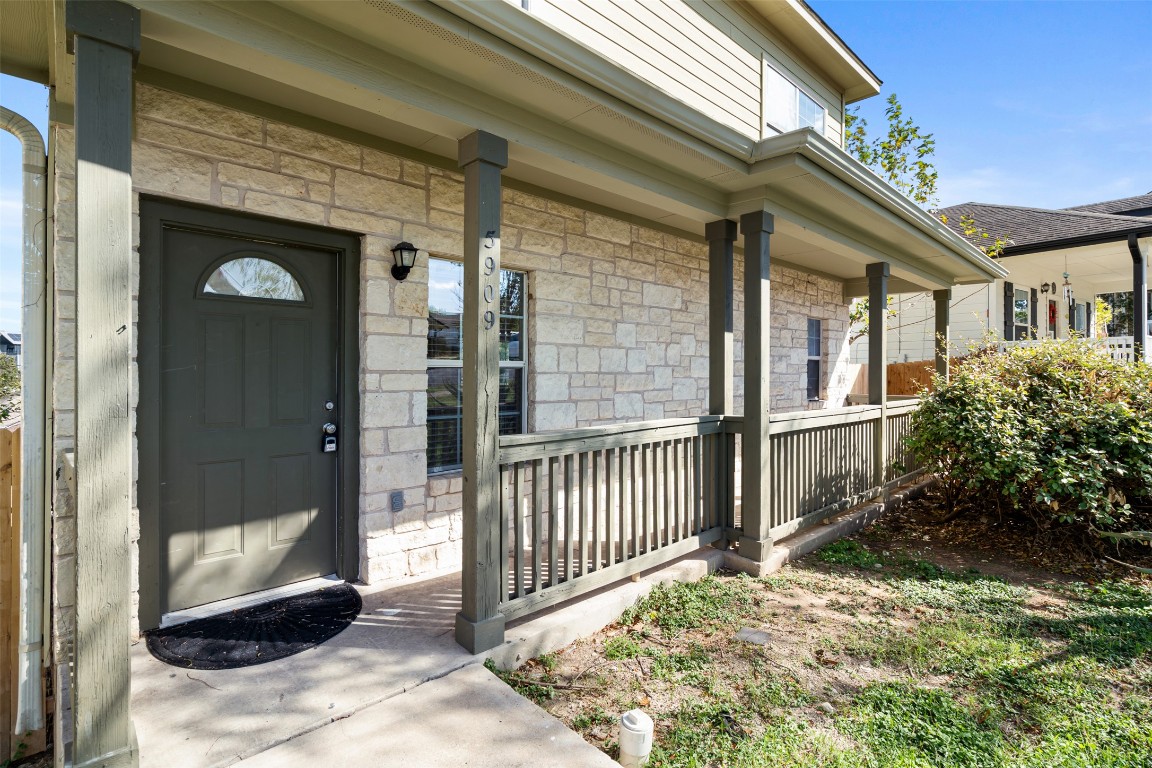 5909 Signal Point Austin, TX 78724 - Photo 3 of 32 a view of a porch with a floor to ceiling window and potted plants
