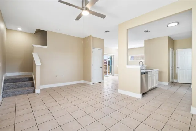 a view of a kitchen with white cabinets and a stove top oven