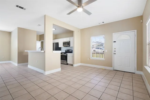 a view of a kitchen with furniture and an empty room