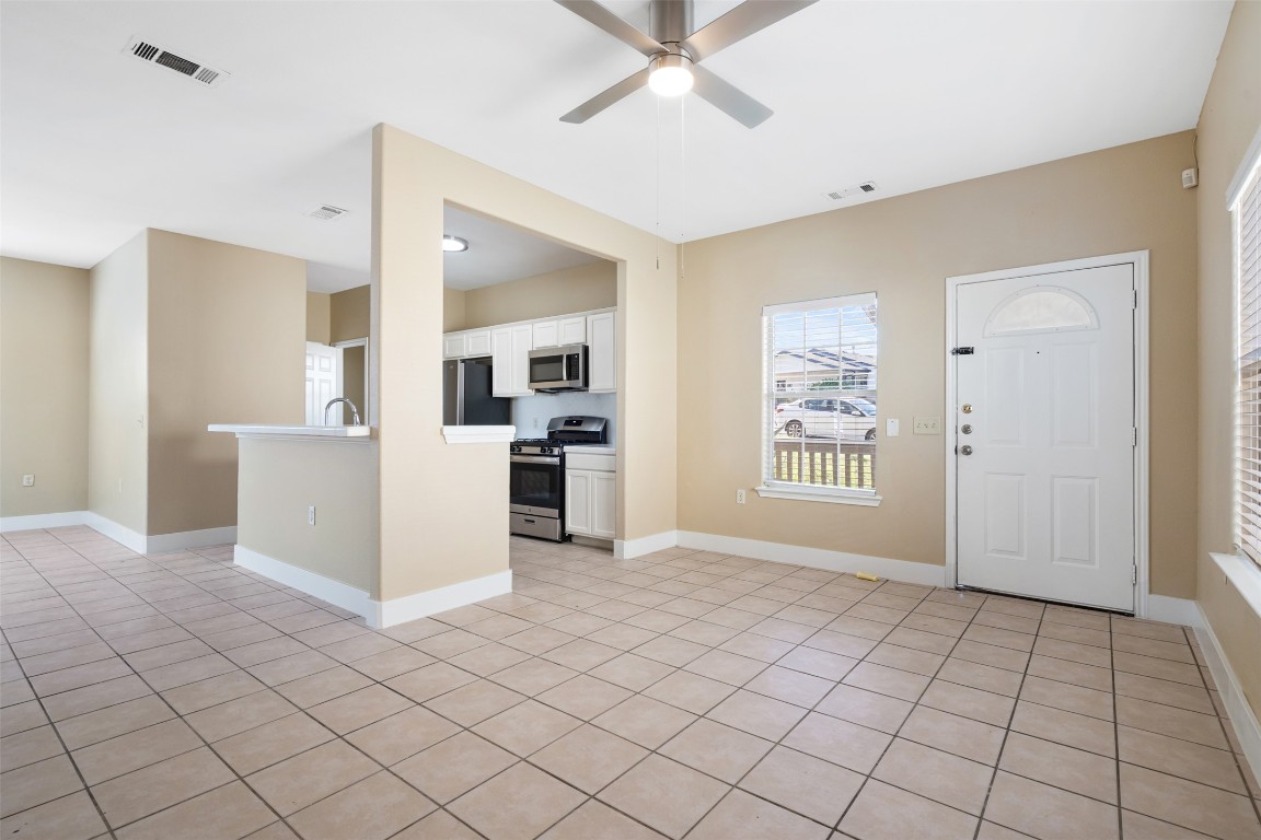 5909 Signal Point Austin, TX 78724 - Photo 7 of 32 a view of a kitchen with furniture and an empty room