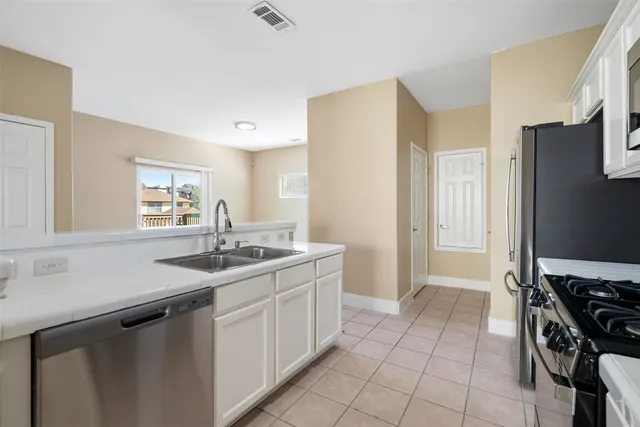 a kitchen with a sink appliances and cabinets