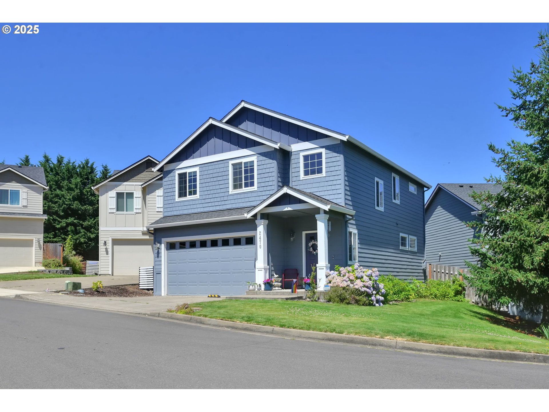 2470 Fieldcress Road Eugene, OR 97403 - Photo 2 of 36 a front view of a house with a yard and garage