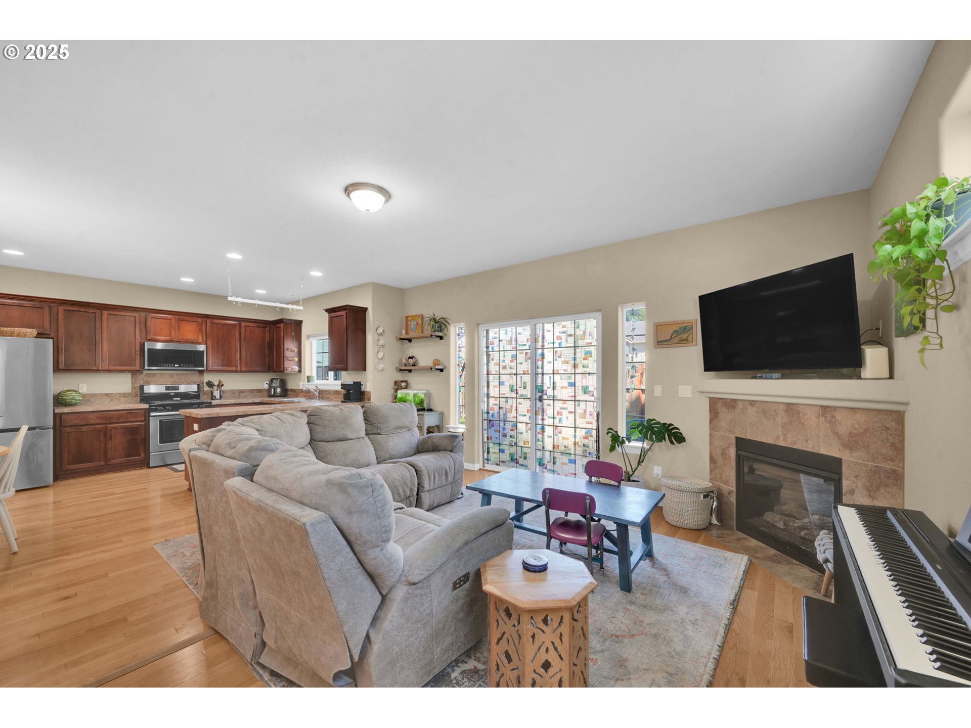 2470 Fieldcress Road Eugene, OR 97403 - Photo 5 of 36 a living room with furniture a flat screen tv and a fireplace
