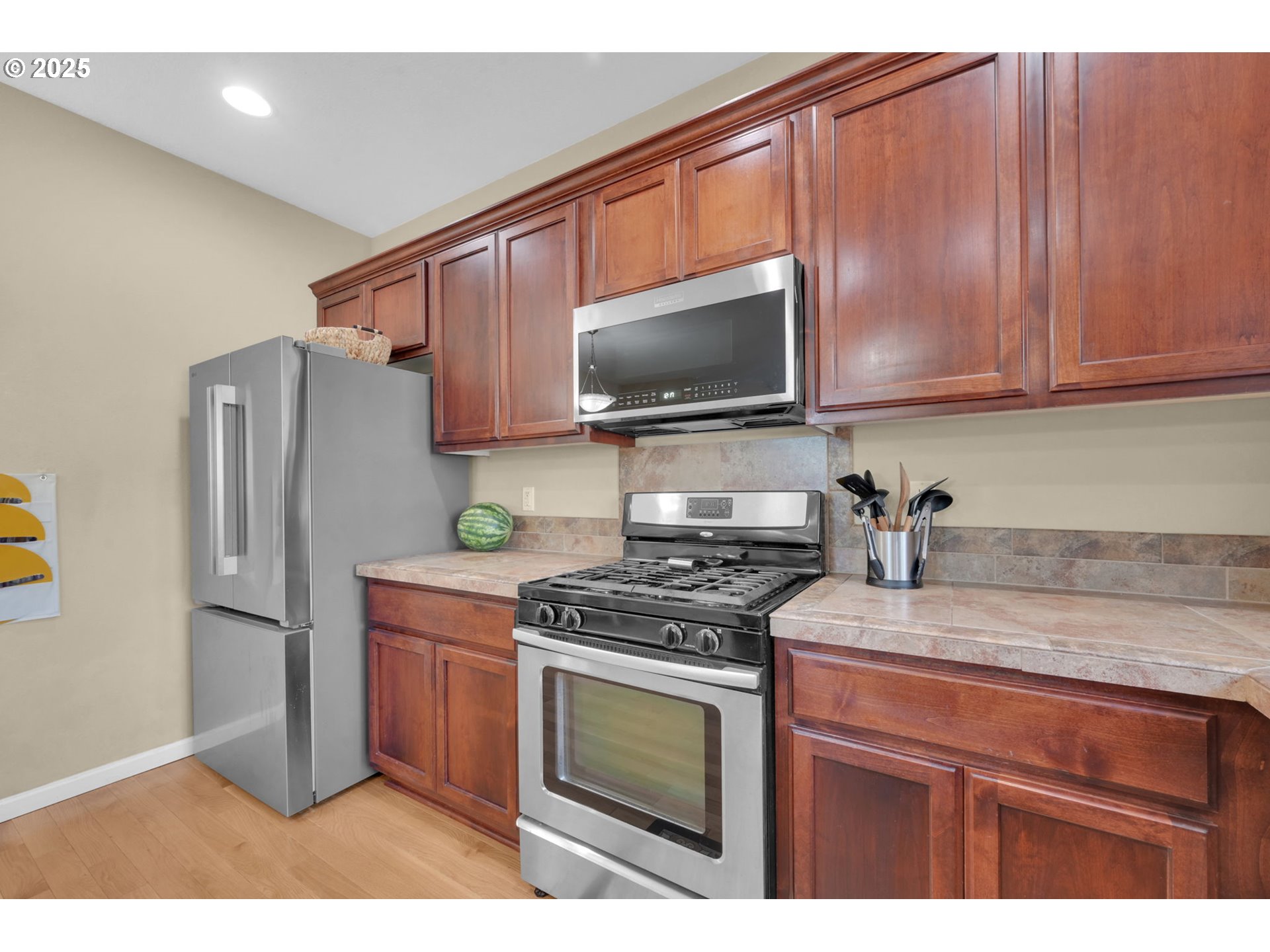 2470 Fieldcress Road Eugene, OR 97403 - Photo 10 of 36 a kitchen with stainless steel appliances granite countertop a stove a refrigerator and a microwave