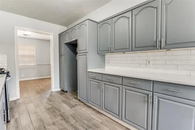 a kitchen with granite countertop a stove and a sink
