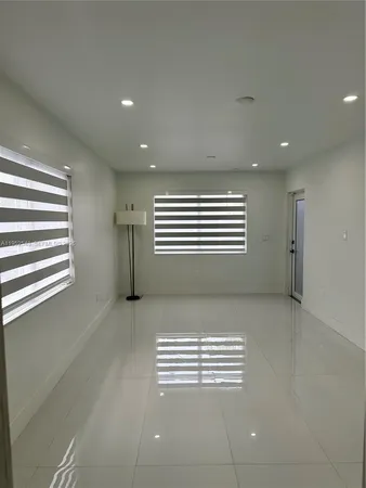 a view of wooden floor and windows in a room