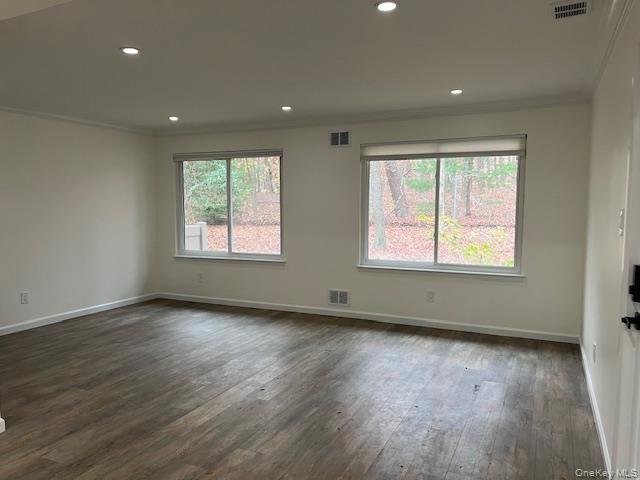 228 Springmeadow Drive, Unit H Holbrook, NY 11741 - Photo 3 of 12 Empty room featuring ornamental molding, plenty of natural light, dark wood-style floors, and recessed lighting