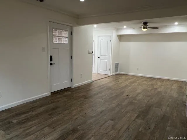 a view of an empty room and wooden floor