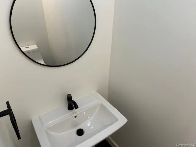 a bathroom with a sink and mirror