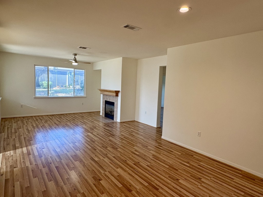 106 Prospector Pass Georgetown, TX 78633 - Photo 3 of 14 a view of empty room with wooden floor and fan