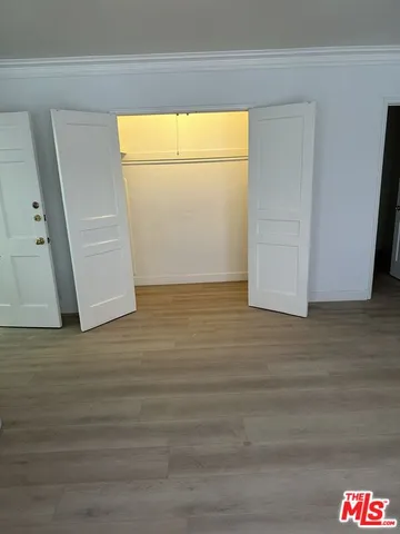 a view of a room with wooden floor and cabinet
