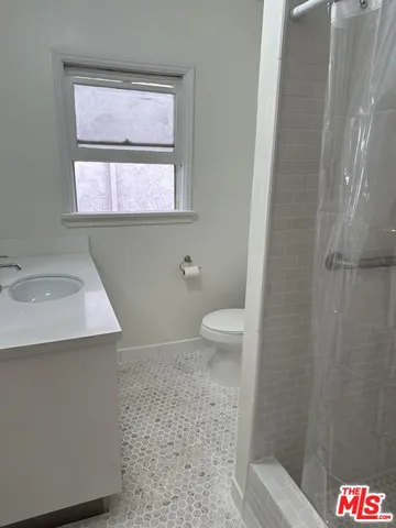 a bathroom with a sink a toilet and mirror