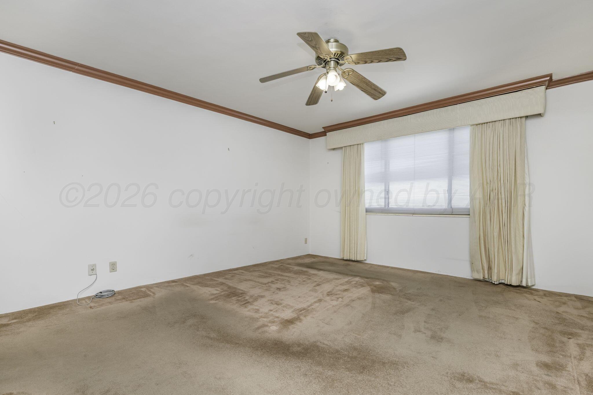 2028 South Austin Street, Unit 902 Amarillo, TX 79109 - Photo 11 of 23 an empty room with windows and fan