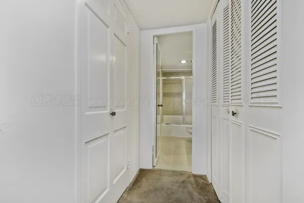 a view of a room with a ceiling fan and a window