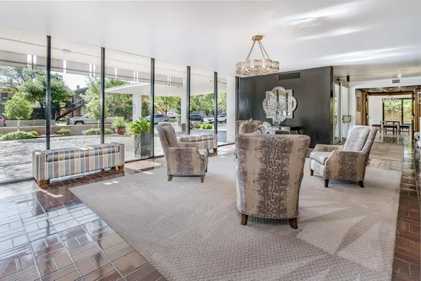 a living room with furniture and a chandelier