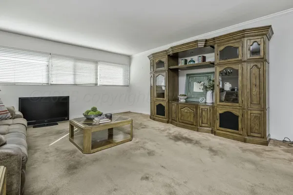 a living room with a fireplace and a flat screen tv