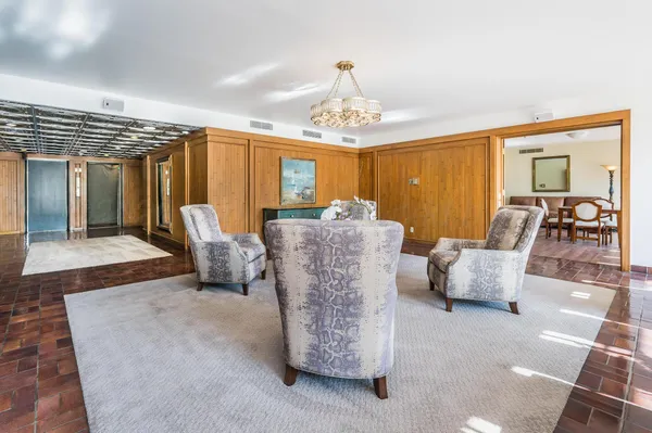 a living room with furniture a window and a chandelier