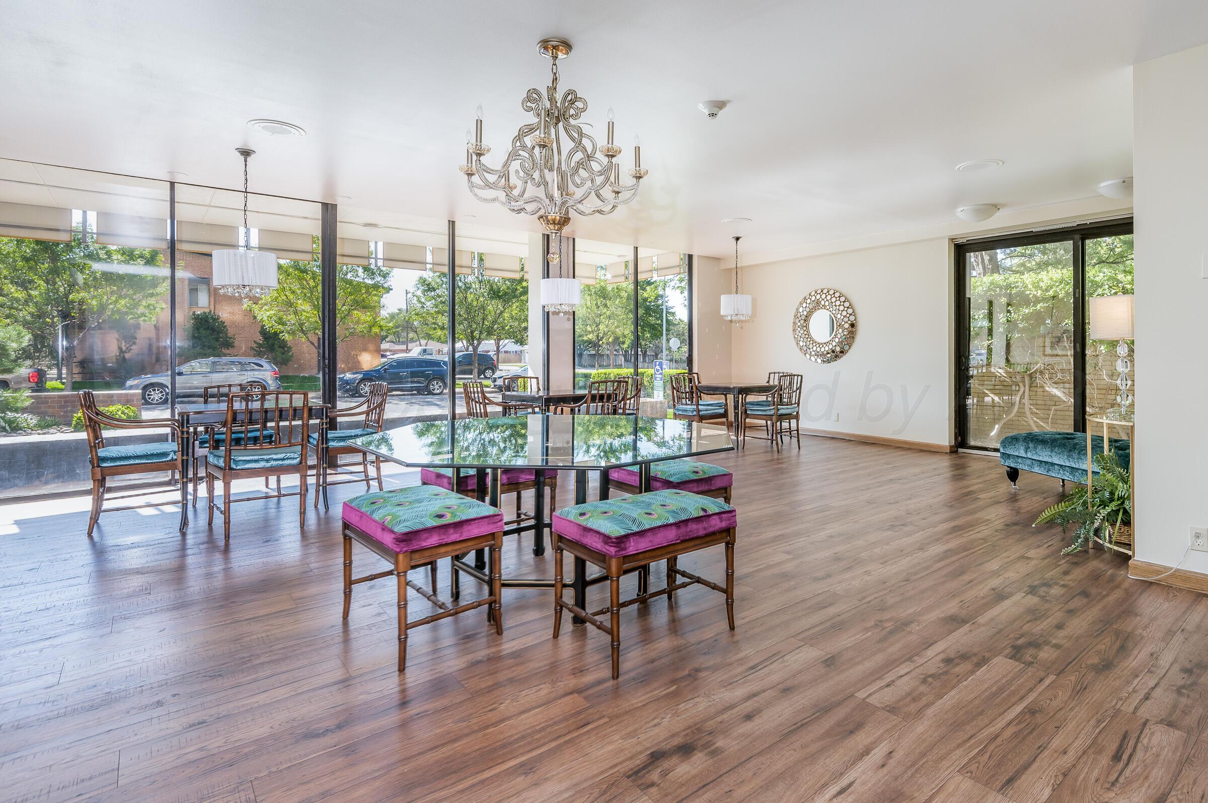 2028 South Austin Street, Unit 902 Amarillo, TX 79109 - Photo 22 of 23 a living room with furniture a window and a chandelier