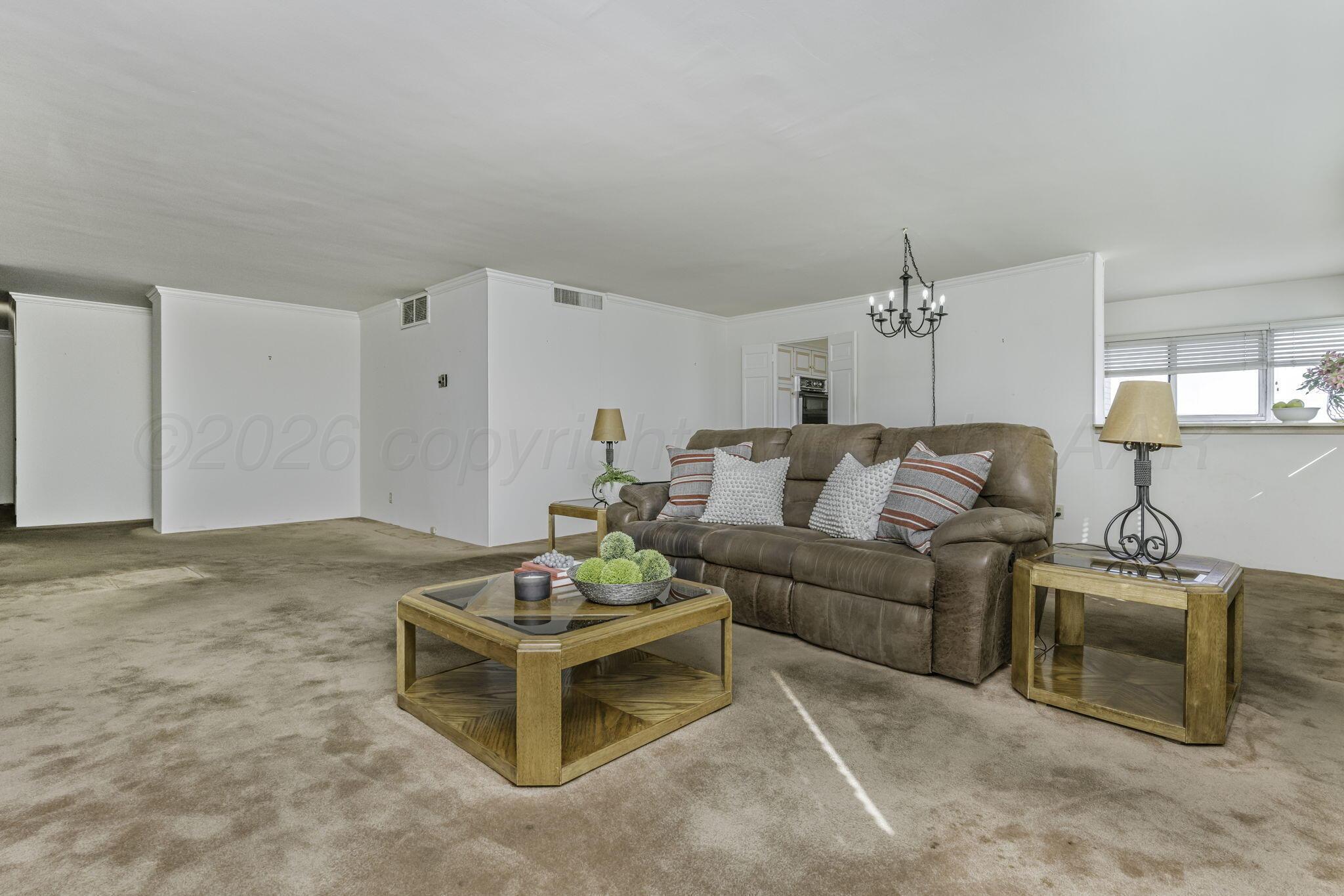 2028 South Austin Street, Unit 902 Amarillo, TX 79109 - Photo 3 of 23 a living room with furniture and a table