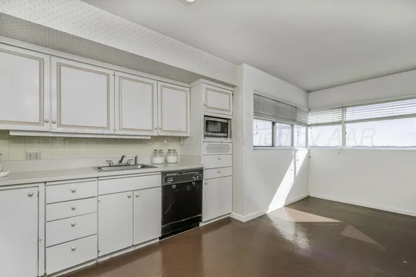 a view of a kitchen with electric appliances