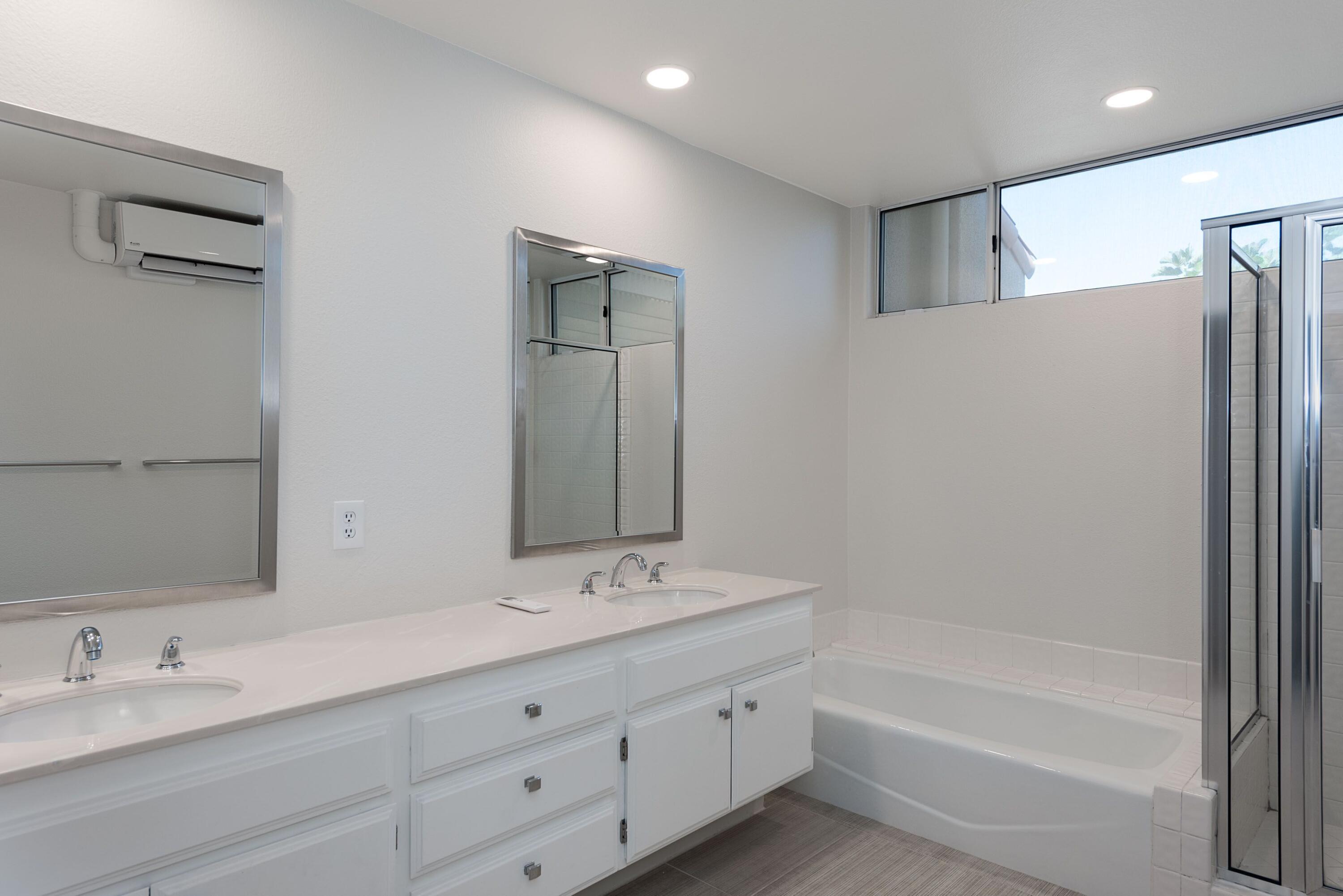 70 Pine Valley Drive Rancho Mirage, CA 92270 - Photo 13 of 31 a bathroom with a tub sink double and mirror