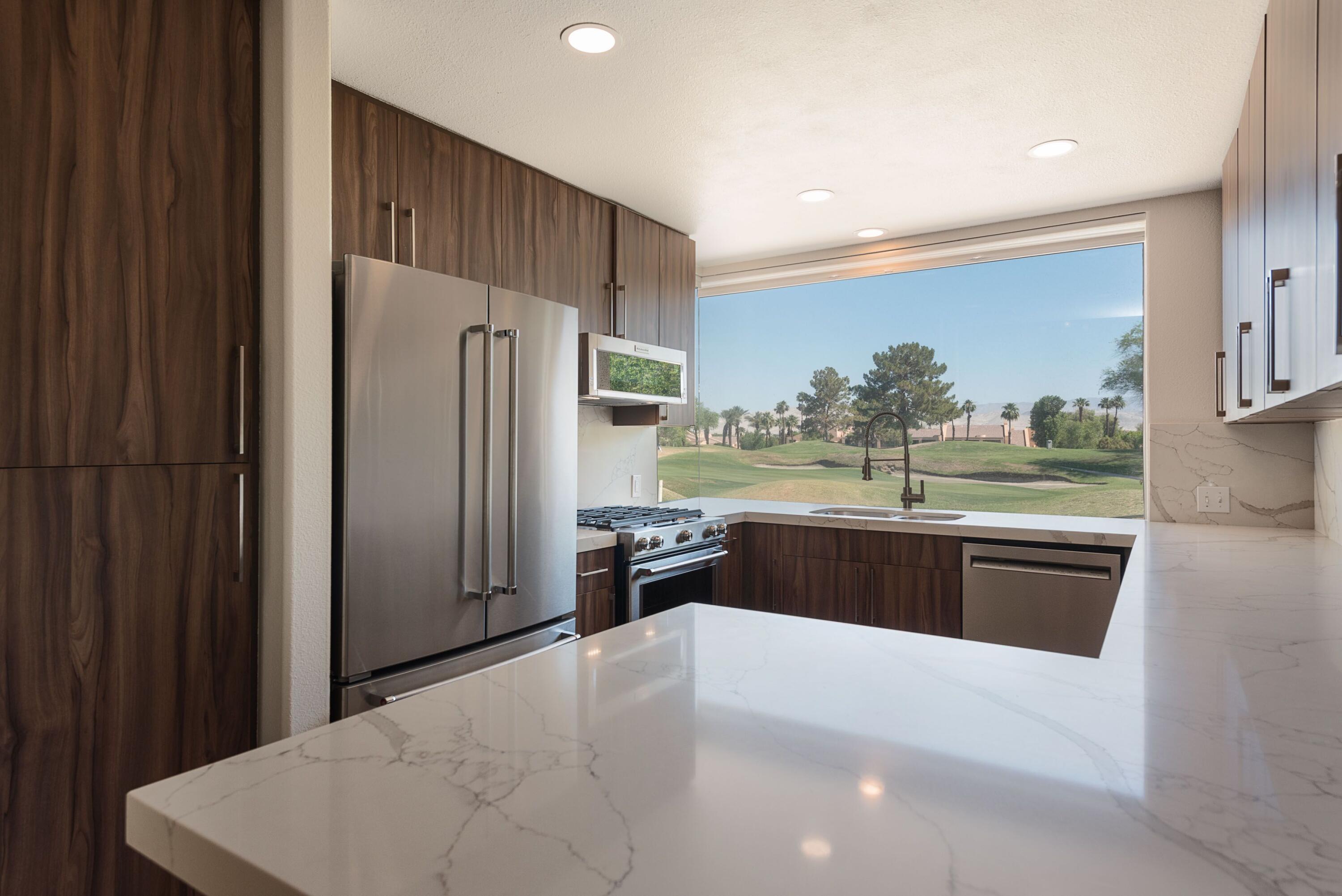 70 Pine Valley Drive Rancho Mirage, CA 92270 - Photo 2 of 31 a kitchen with stainless steel appliances a refrigerator and a stove top oven
