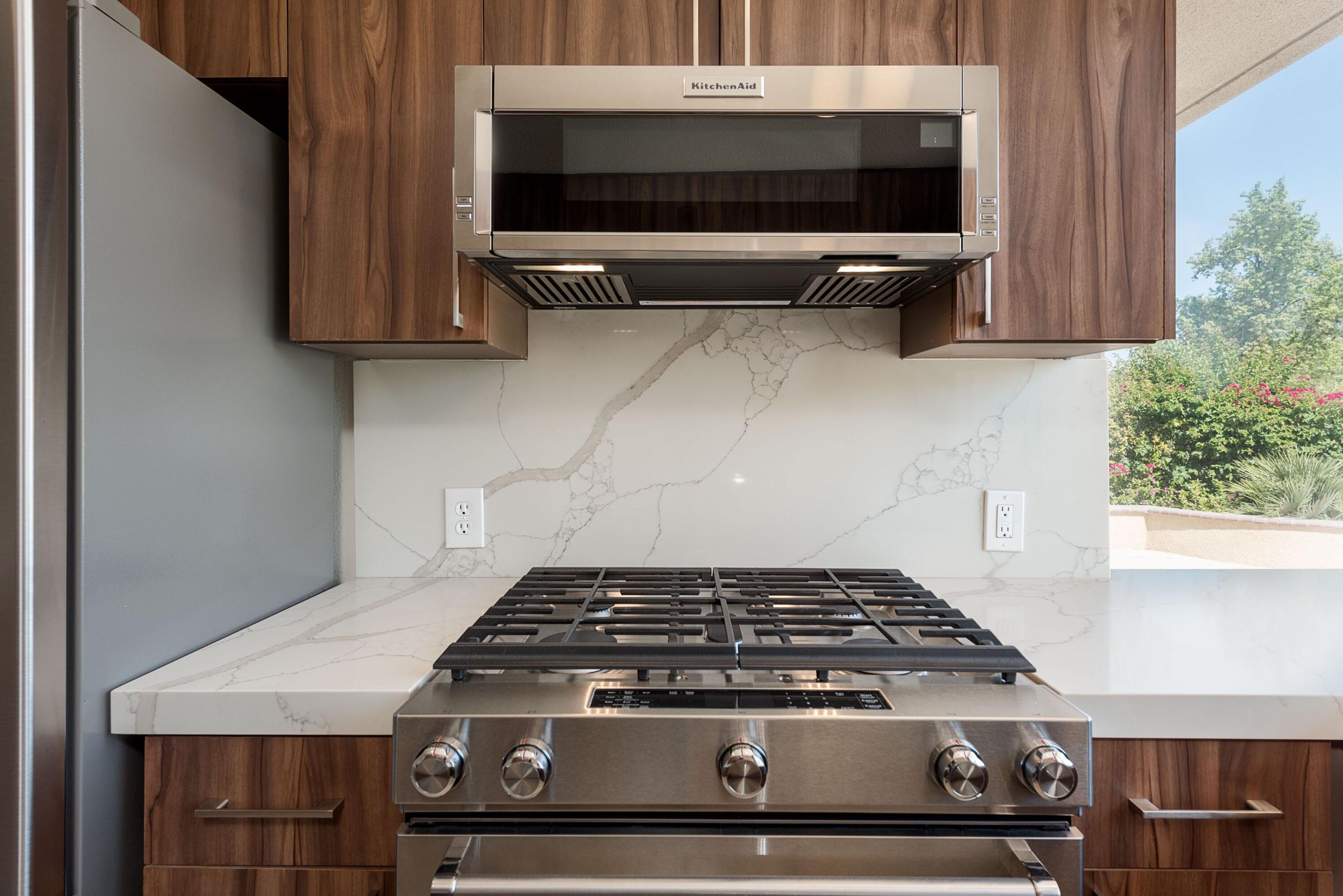 70 Pine Valley Drive Rancho Mirage, CA 92270 - Photo 3 of 31 a stove top oven sitting inside of a kitchen