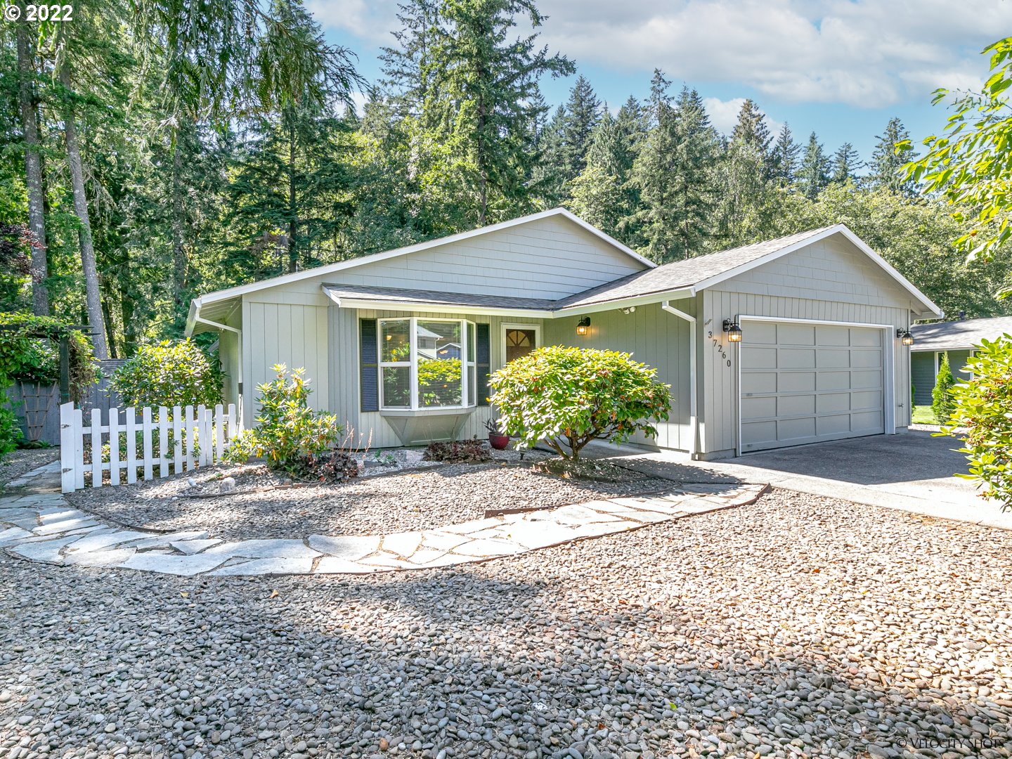 37260 Dubarko Road Sandy, OR 97055 - Photo 1 of 32 a view of a house with a yard and flower plants