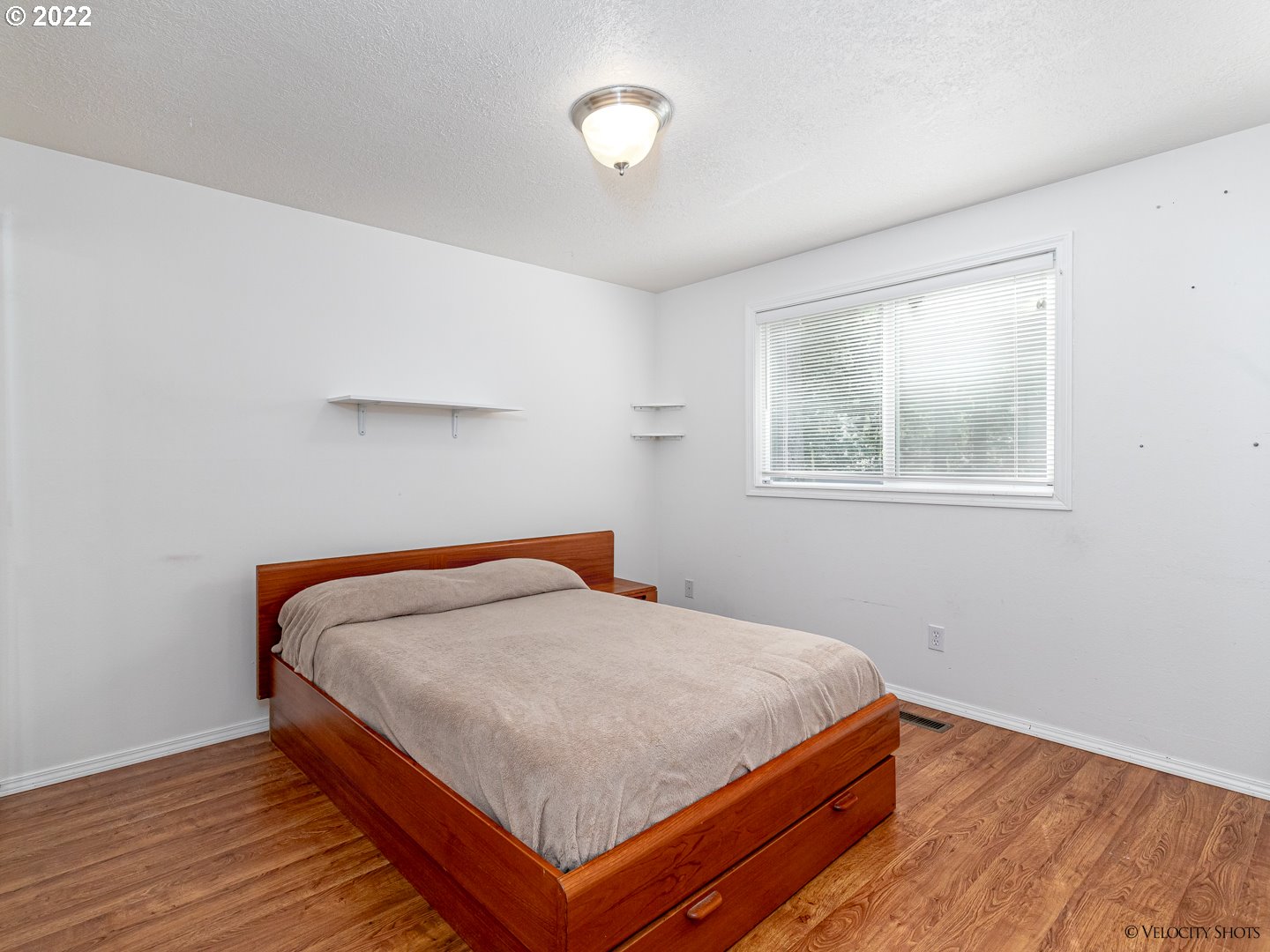 37260 Dubarko Road Sandy, OR 97055 - Photo 22 of 32 a bedroom with a bed and wooden floor