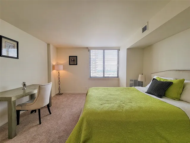 a bedroom with a bed and a table